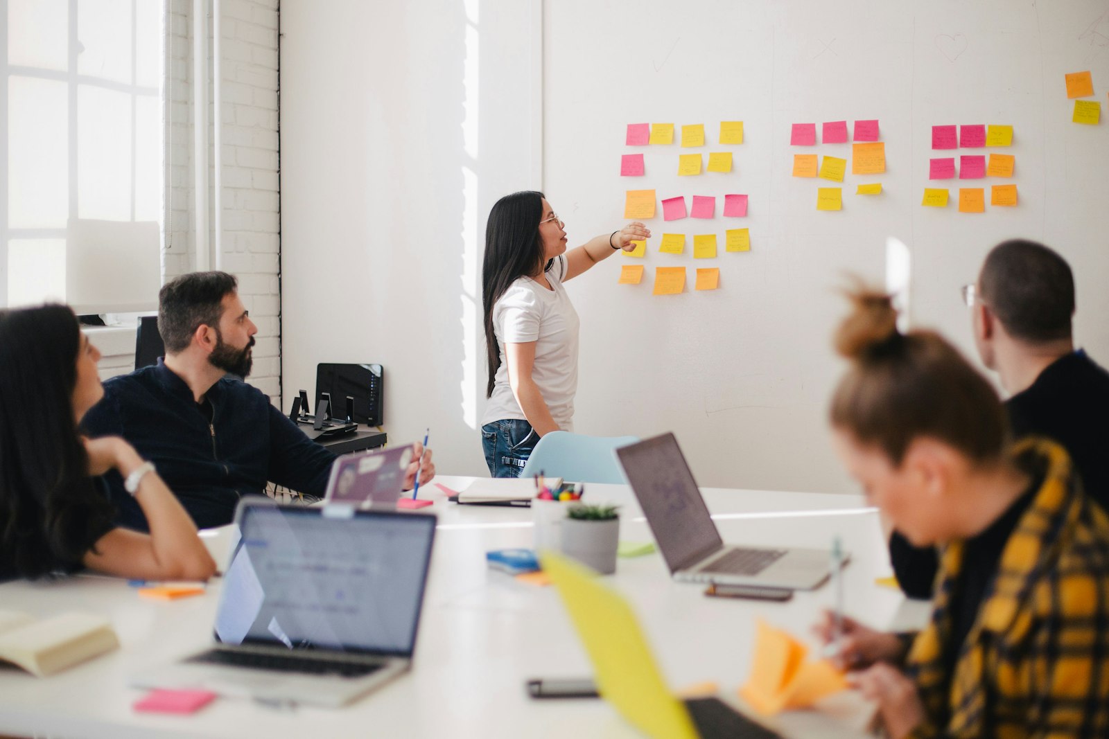 A facilitator mapping budget categories on a wall during an AI finance foundations column